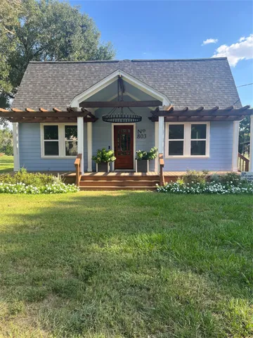 a front view of a house with a garden and yard