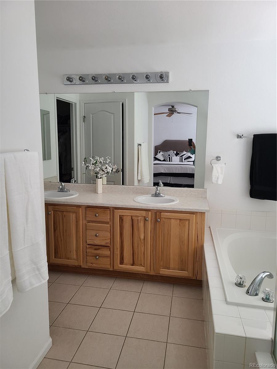 9492 Cedarhurst Lane, Unit B Highlands Ranch, CO 80129 - Photo 13 of 17 a bathroom with a sink and a mirror