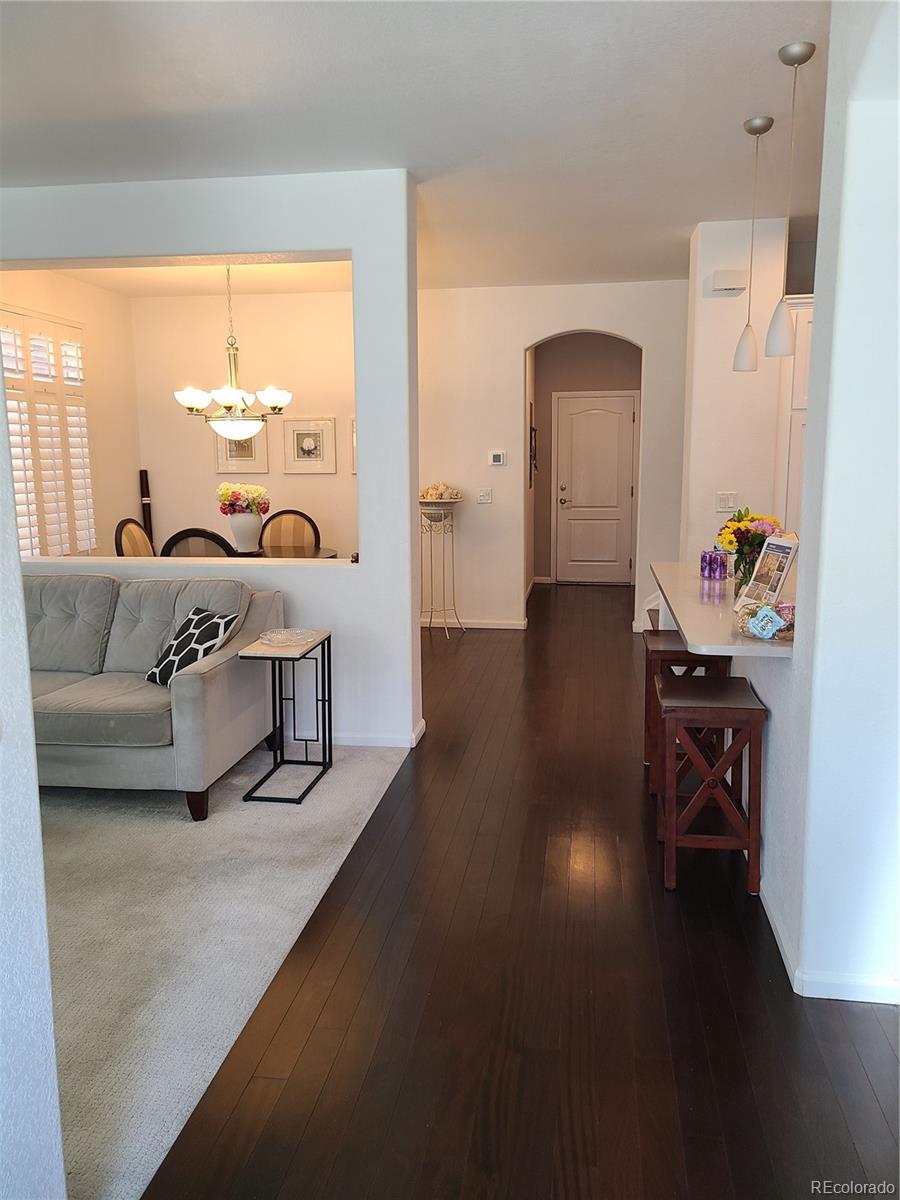 9492 Cedarhurst Lane, Unit B Highlands Ranch, CO 80129 - Photo 2 of 17 a living room with furniture and wooden floor
