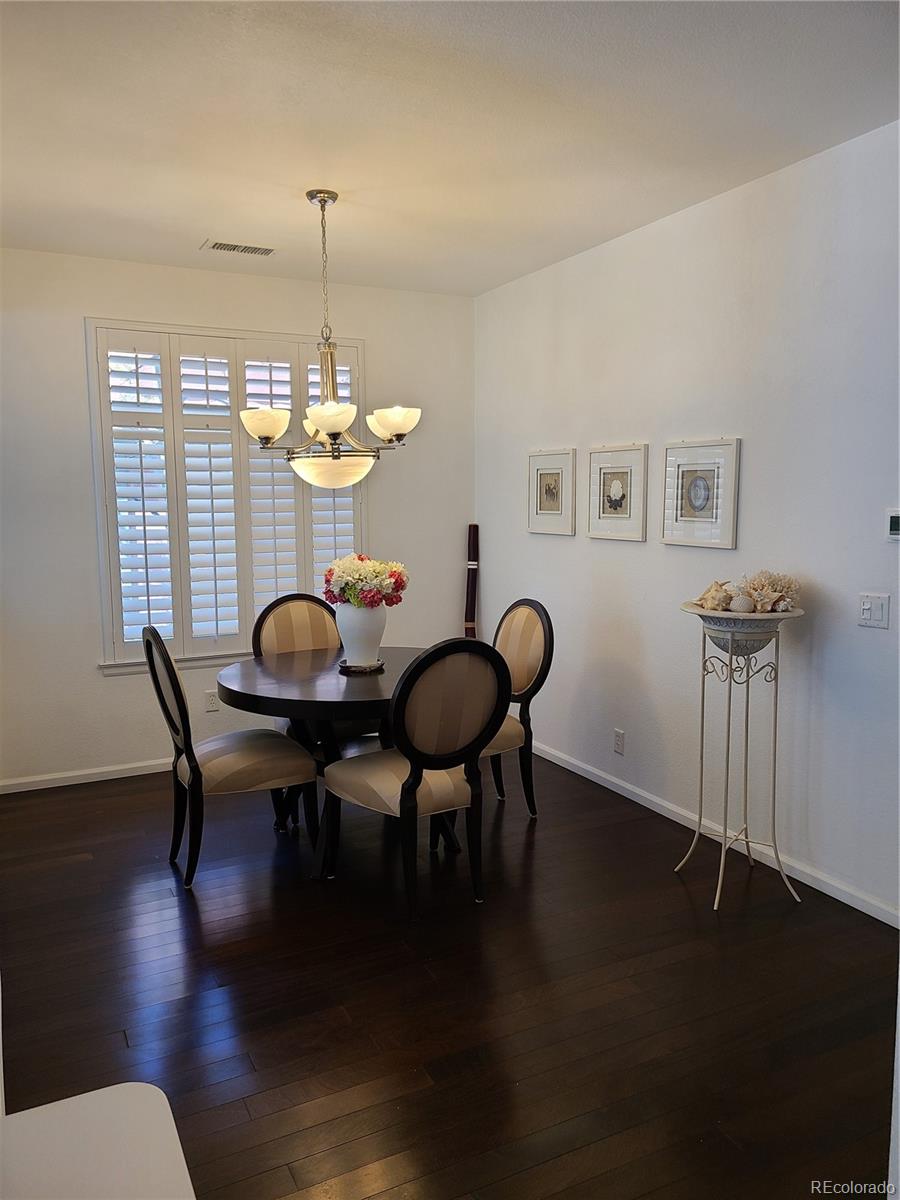 9492 Cedarhurst Lane, Unit B Highlands Ranch, CO 80129 - Photo 3 of 17 a view of a dining room with furniture window and wooden floor