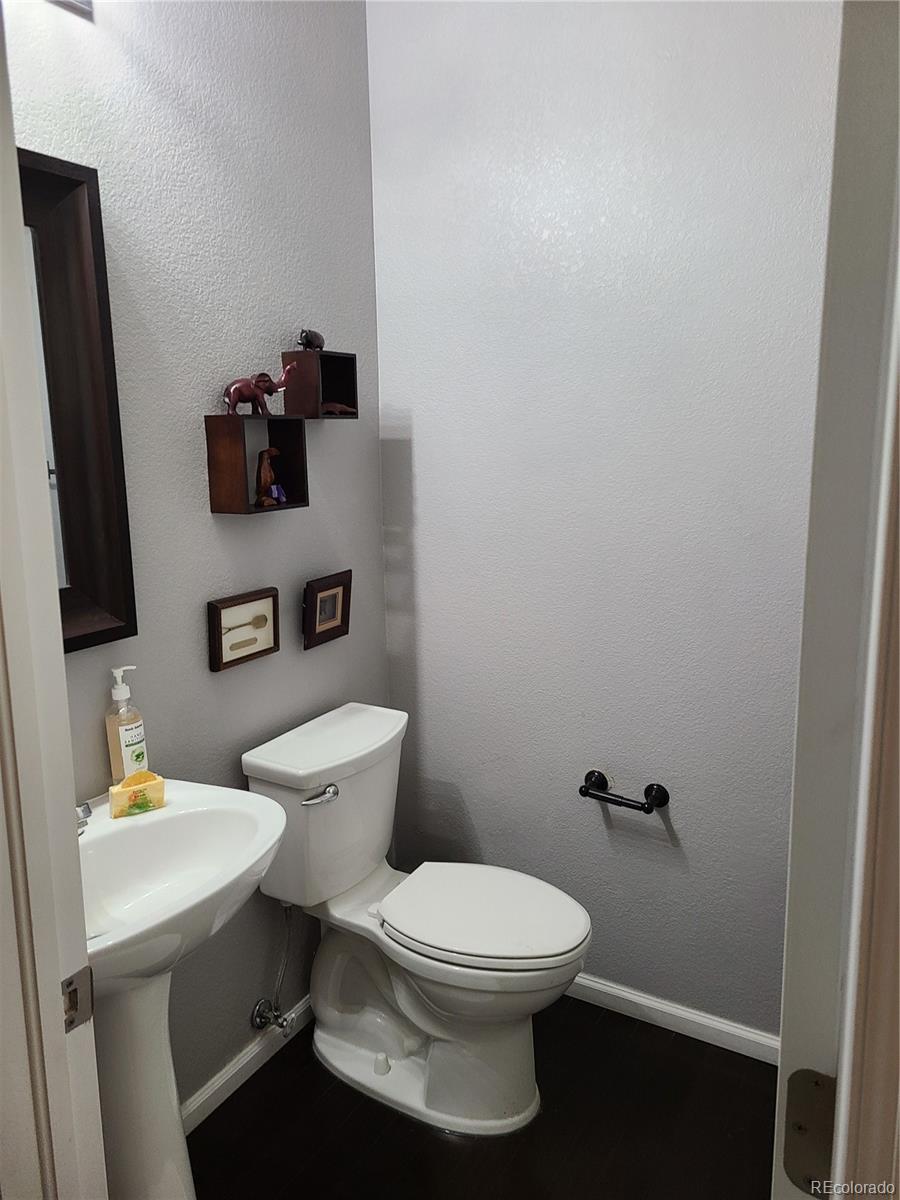 9492 Cedarhurst Lane, Unit B Highlands Ranch, CO 80129 - Photo 7 of 17 a bathroom with a toilet sink and mirror