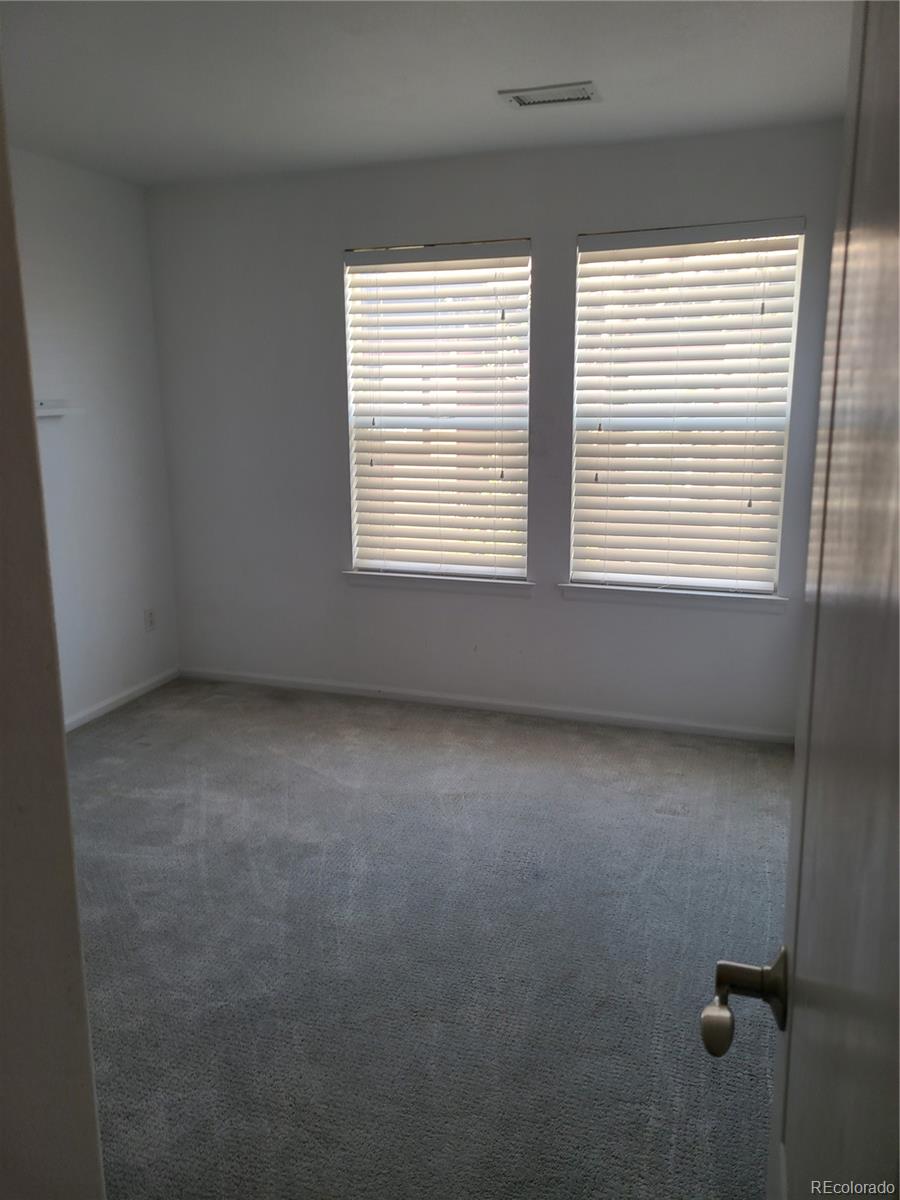 9492 Cedarhurst Lane, Unit B Highlands Ranch, CO 80129 - Photo 9 of 17 an empty room with a window