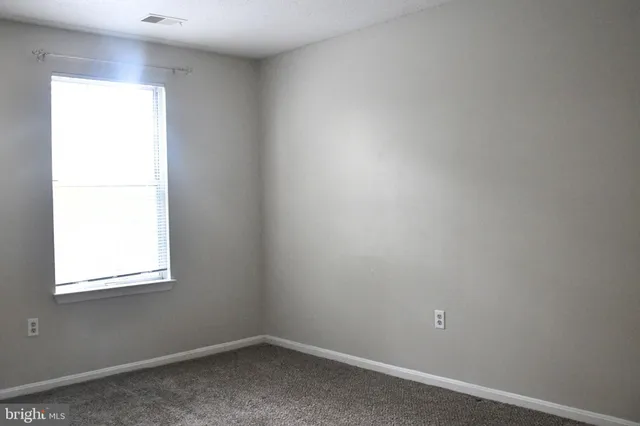 a white bath tub sitting next to a toilet