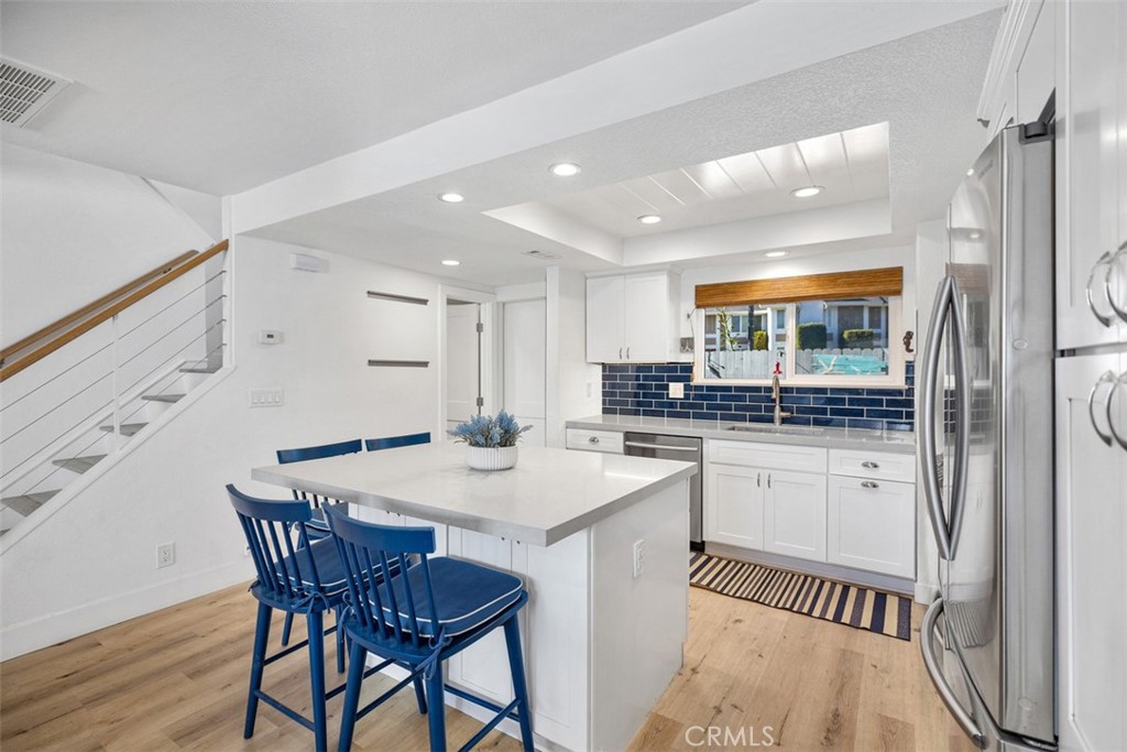 24562 Harbor View Drive, Unit 18 Dana Point, CA 92629 - Photo 11 of 33 a kitchen with stainless steel appliances granite countertop a dining table chairs and granite counter tops