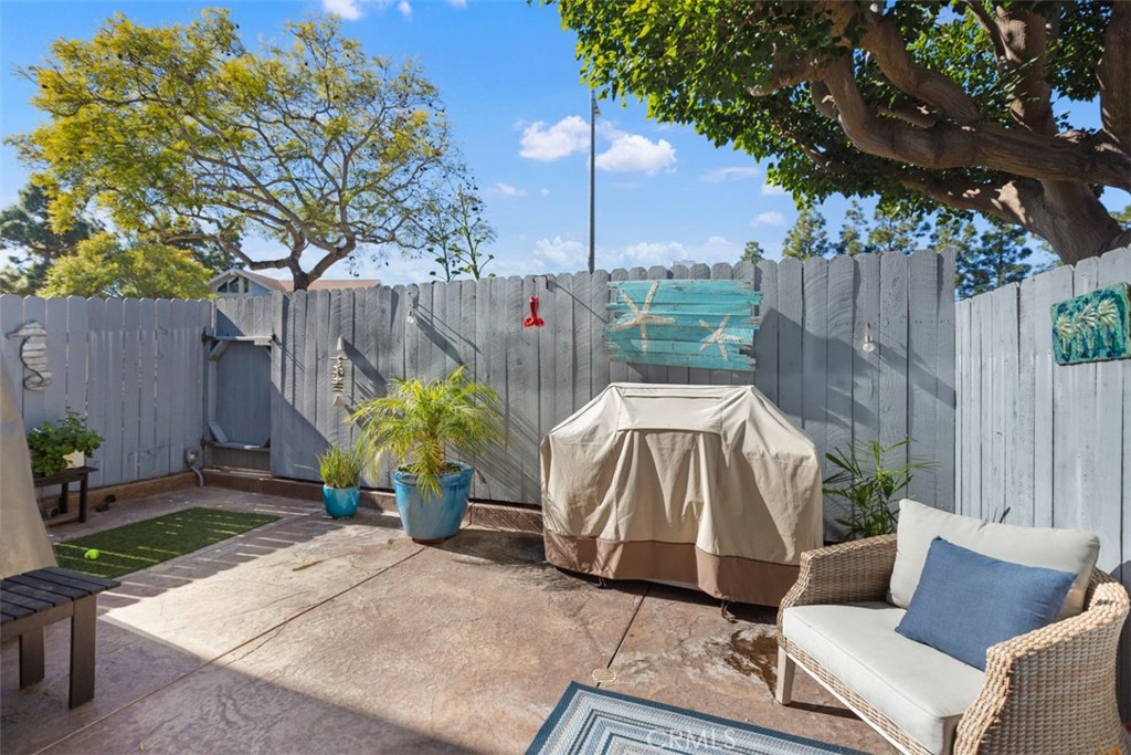24562 Harbor View Drive, Unit 18 Dana Point, CA 92629 - Photo 24 of 33 a view of patio with a table and chairs under an umbrella