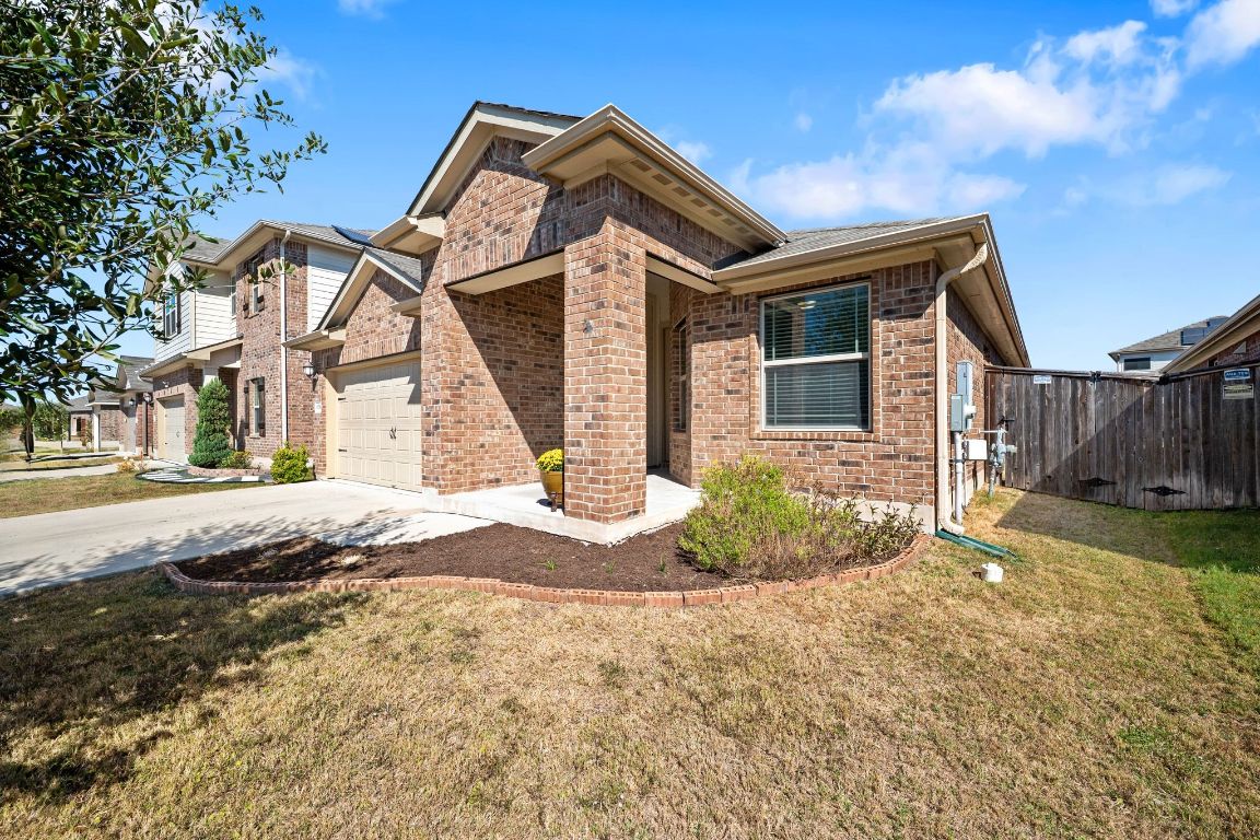 13716 Fallsprings Way Manor, TX 78653 - Photo 1 of 1 a front view of a house with a yard