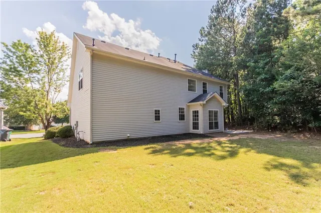 a view of a house with a yard and garage