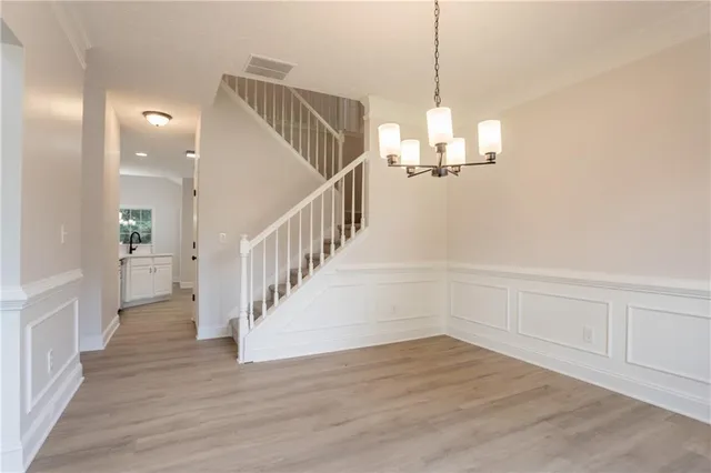 a view of entryway and hall with wooden floor