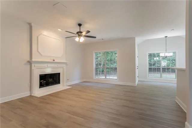 wooden floor fireplace and windows in an empty room