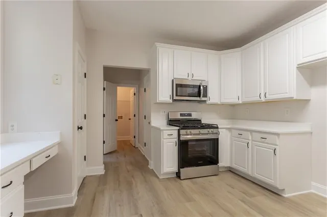 a kitchen with a stove a sink and a refrigerator