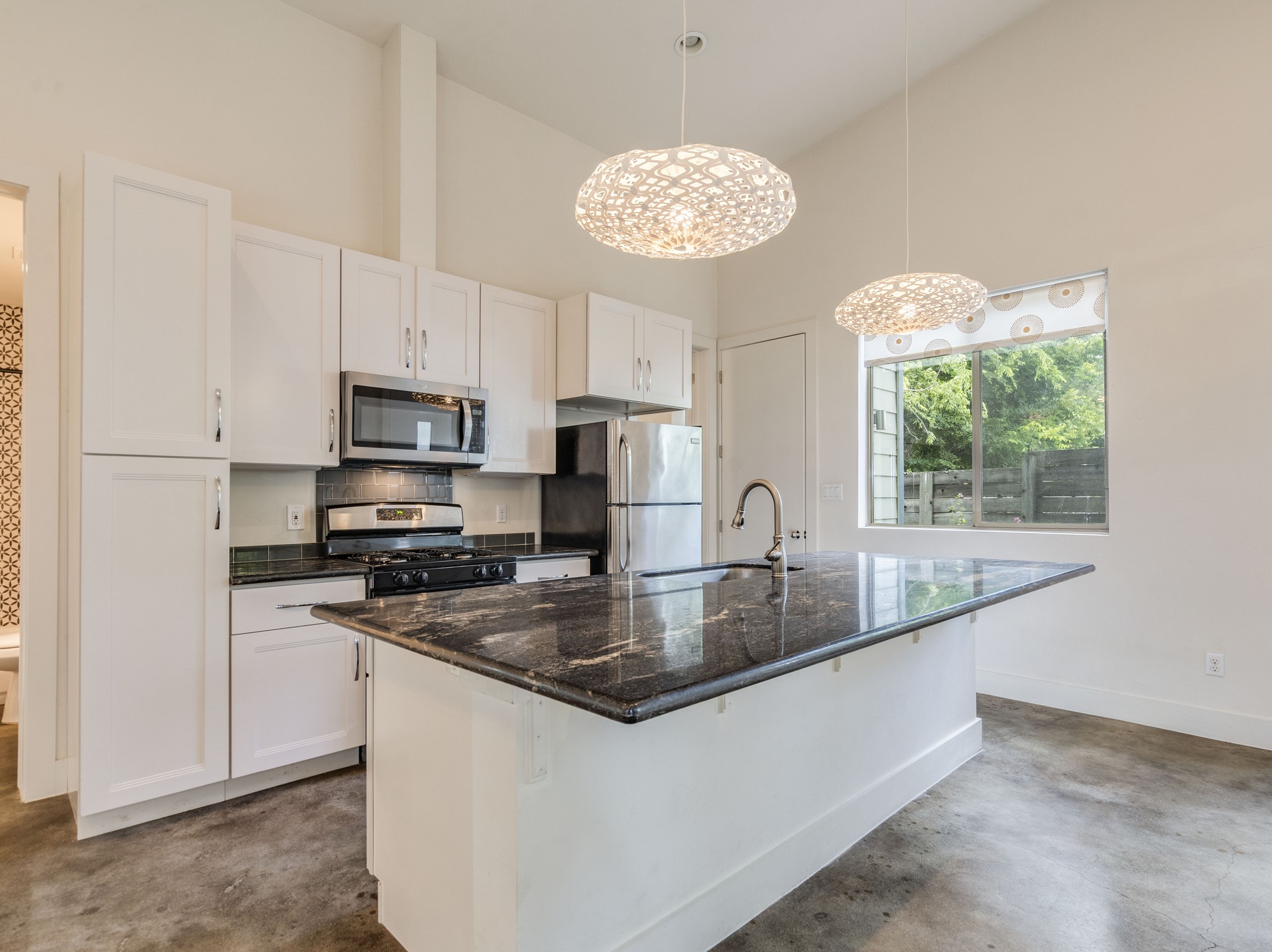 1404 Singleton Avenue, Unit B Austin, TX 78702 - Photo 5 of 21 Culinary adventures await in this modern kitchen featuring an island with ample counter space.
