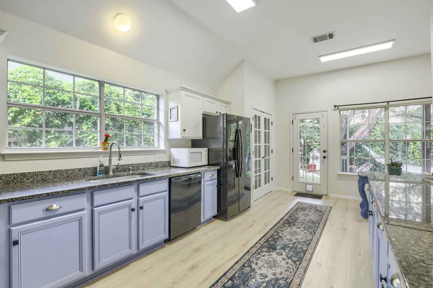206 Gann Street Georgetown, TX 78626 - Photo 8 of 19 a kitchen with stainless steel appliances granite countertop sink stove refrigerator and cabinets