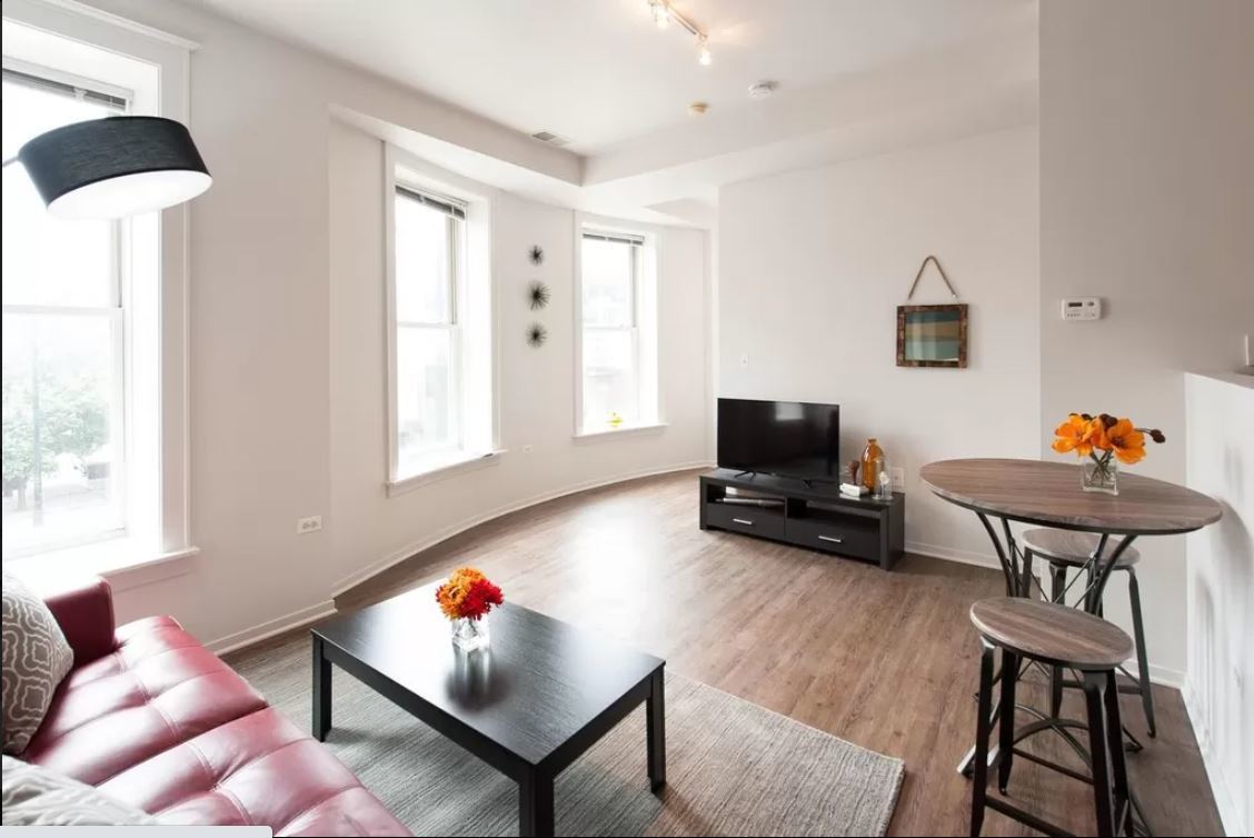 30 East Roosevelt Road, Unit 502 Chicago, IL 60605 - Photo 3 of 5 a living room with furniture and a wooden floor