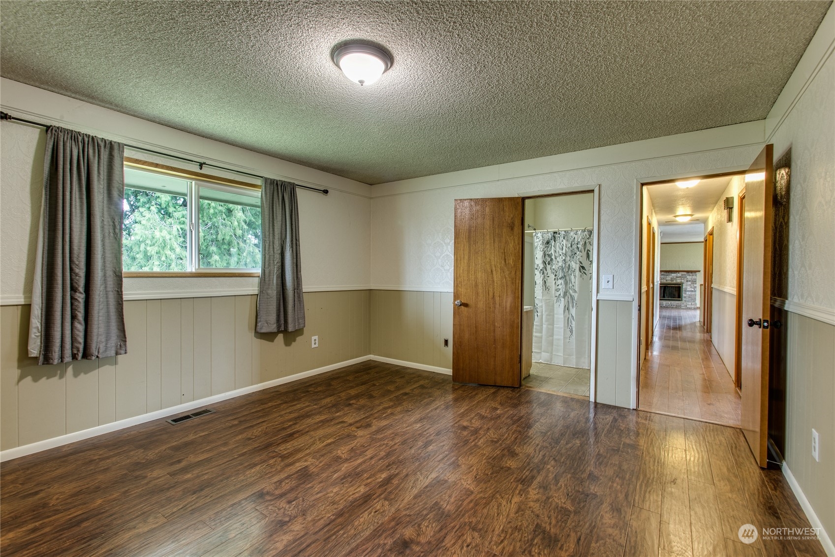 8130 Gillies Road Everson, WA 98247 - Photo 13 of 39 an empty room with wooden floor and a window