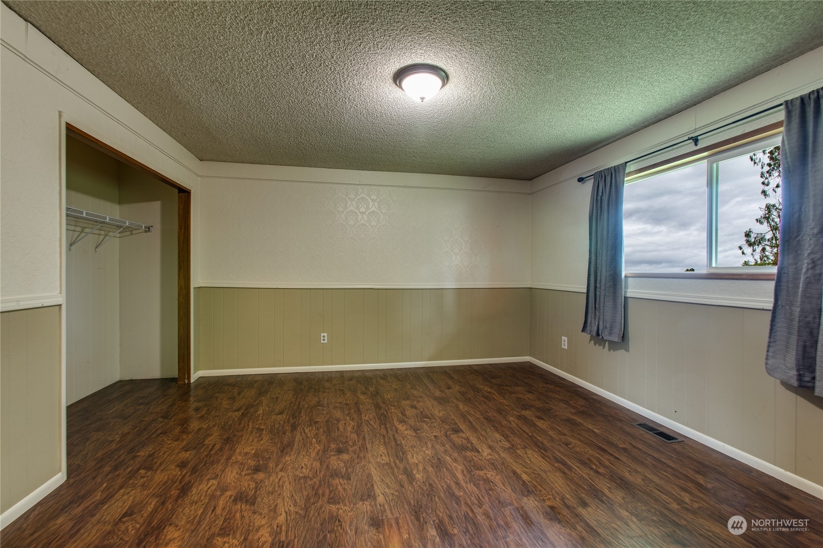 8130 Gillies Road Everson, WA 98247 - Photo 14 of 39 a view of an empty room with wooden floor and a window
