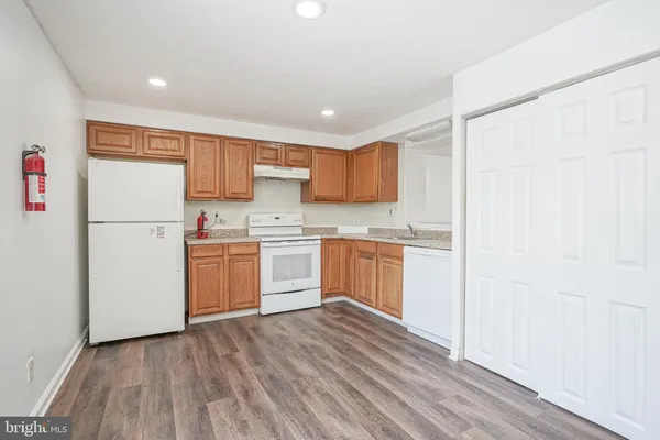 a kitchen with a refrigerator a sink and cabinets