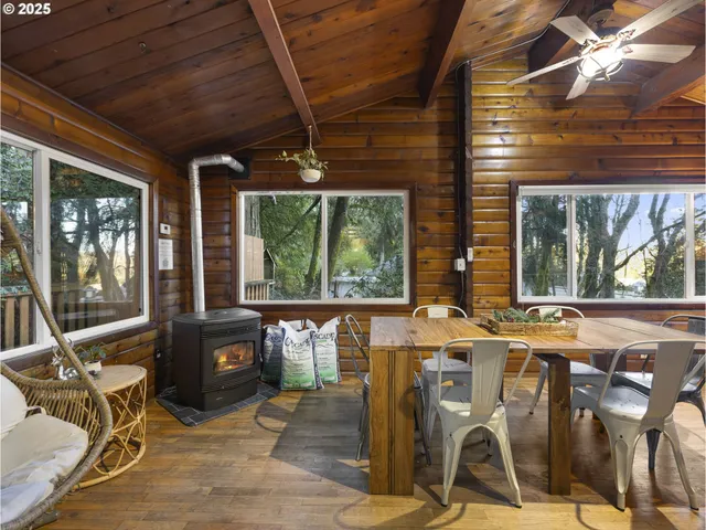 a view of a patio with table and chairs a barbeque with wooden floor