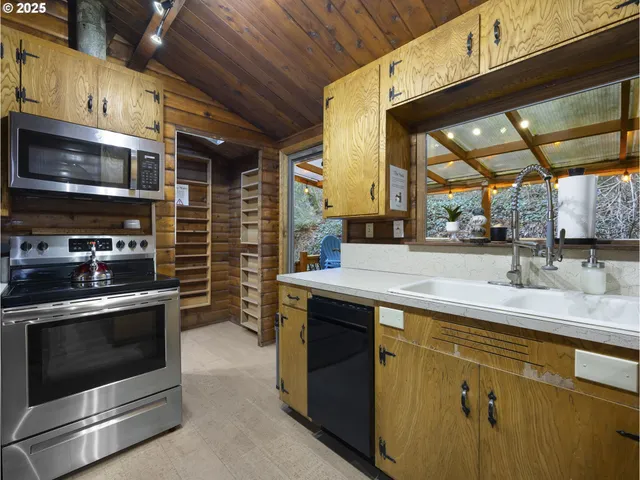 a kitchen with stainless steel appliances granite countertop a stove and a sink