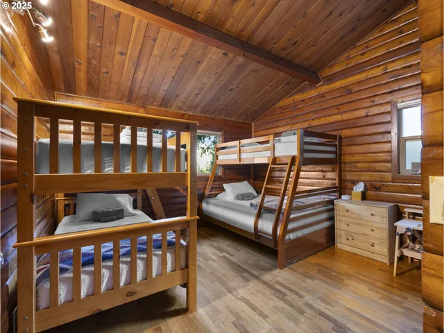 a bedroom with furniture and wooden floor