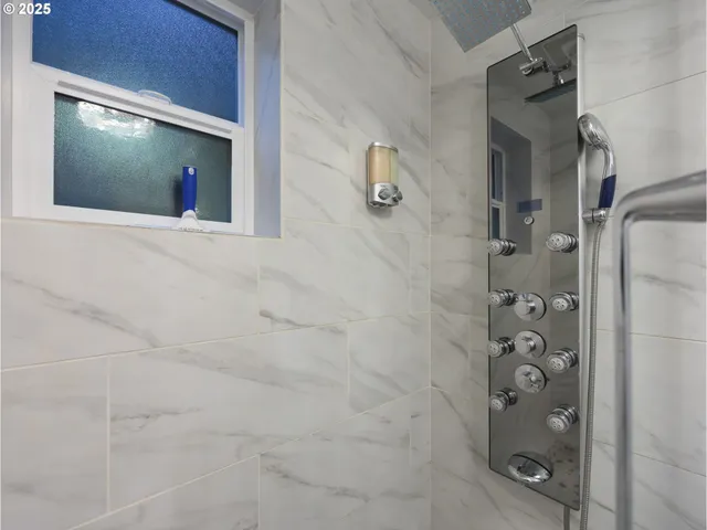 a bathroom with a mirror and a shower