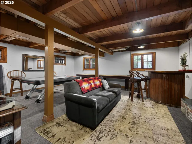 a living room with furniture a rug and wooden floor