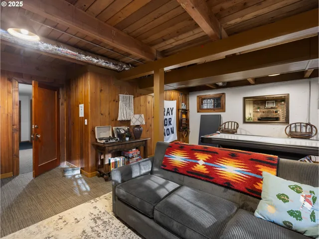a living room with furniture pool table and a fireplace