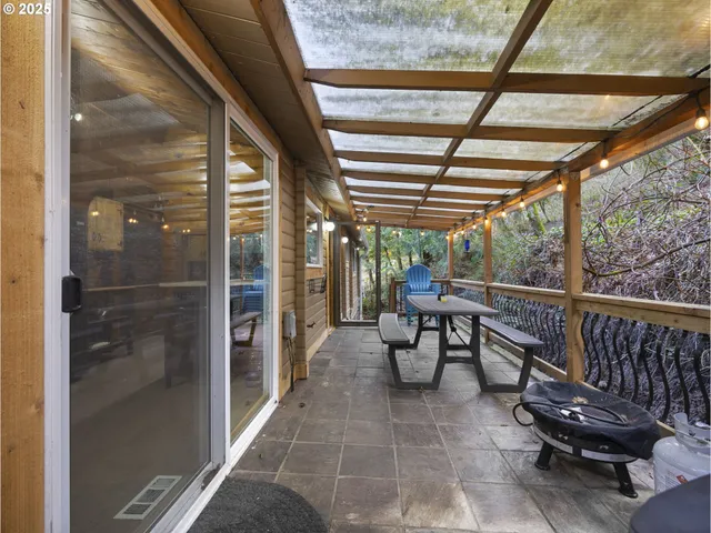 a view of a porch with chairs and backyard