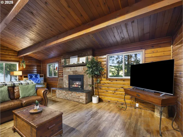 a living room with fireplace furniture and a flat screen tv
