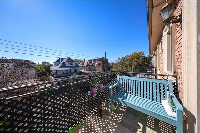 a view of a balcony with wooden chairs