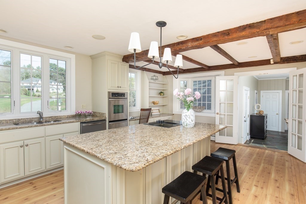 55 Sunset Rock Road Andover, MA 01810 - Photo 12 of 36 a kitchen with center island and living room