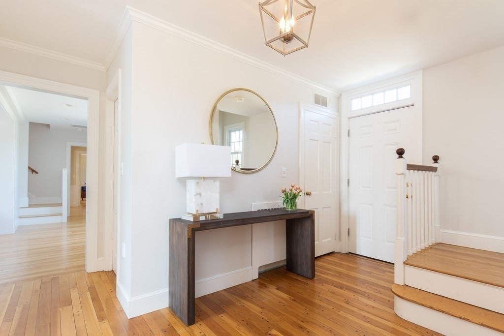 55 Sunset Rock Road Andover, MA 01810 - Photo 14 of 36 a view of a livingroom with furniture wooden floor and a chandelier