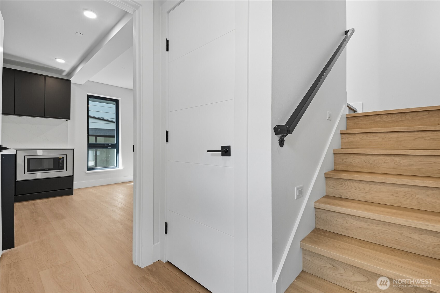 218 21st Avenue East Seattle, WA 98112 - Photo 19 of 38 a view of a hallway with wooden floor and staircase