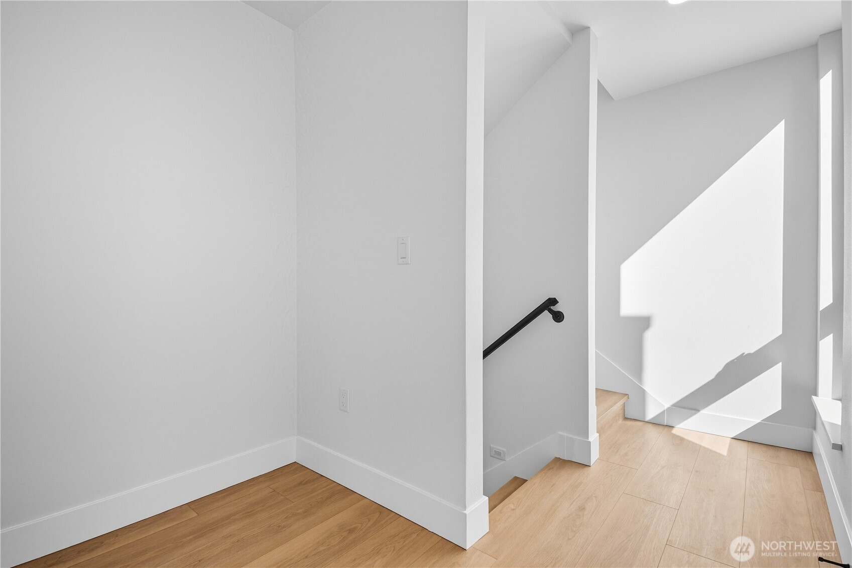 218 21st Avenue East Seattle, WA 98112 - Photo 25 of 38 a view of a hallway with wooden floor and stairs