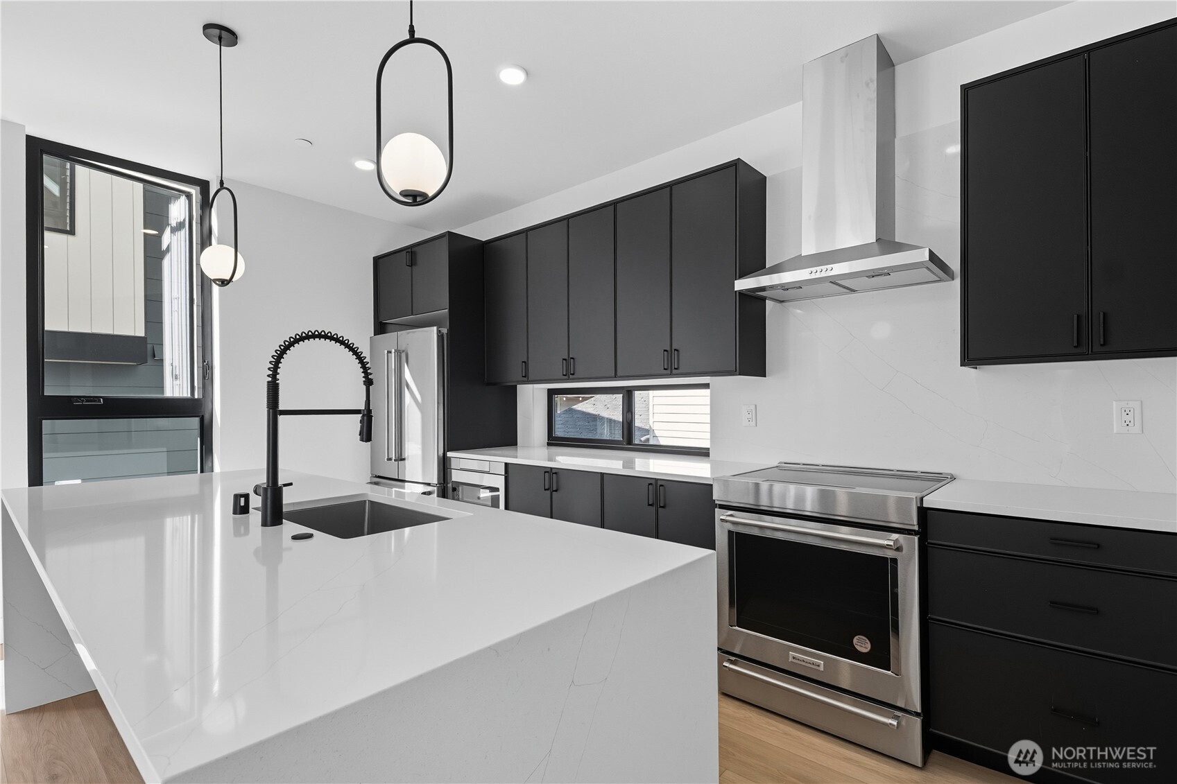 218 21st Avenue East Seattle, WA 98112 - Photo 6 of 38 a kitchen with stainless steel appliances a stove a sink and a microwave