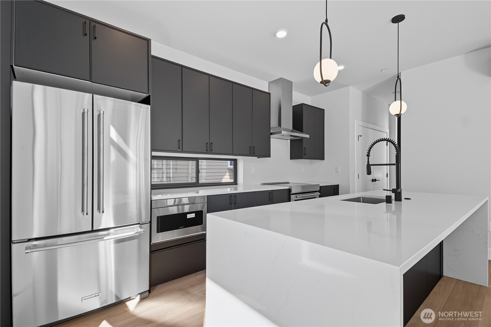 218 21st Avenue East Seattle, WA 98112 - Photo 9 of 38 a kitchen with stainless steel appliances a refrigerator sink and microwave