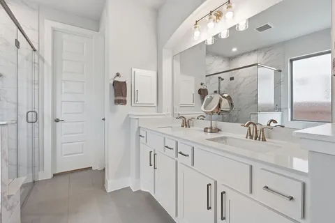 a bathroom with a double vanity sink mirror and