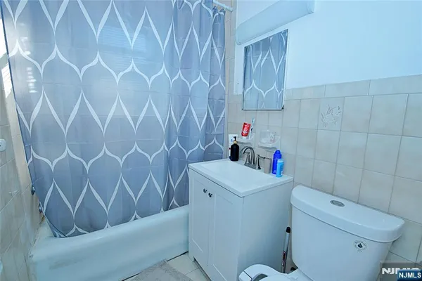 a bathroom with a toilet and a shower curtain