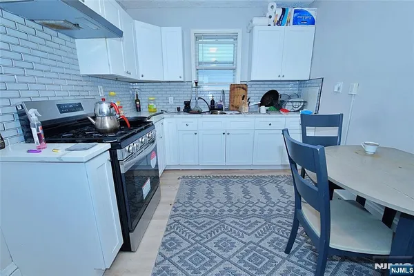 a kitchen with a sink cabinets and window