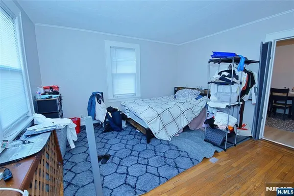 a bedroom with furniture and a wooden floor