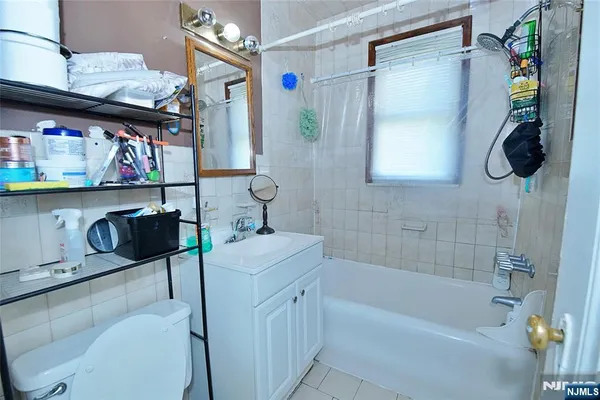 a bathroom with a sink a toilet and bathtub