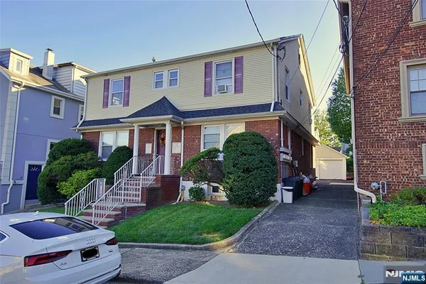 a front view of a house with garden