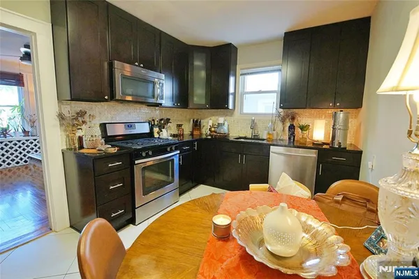 a kitchen with a sink a stove and microwave