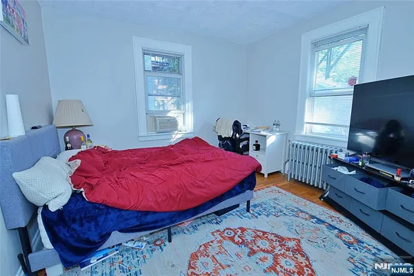 a bedroom with bed and a window