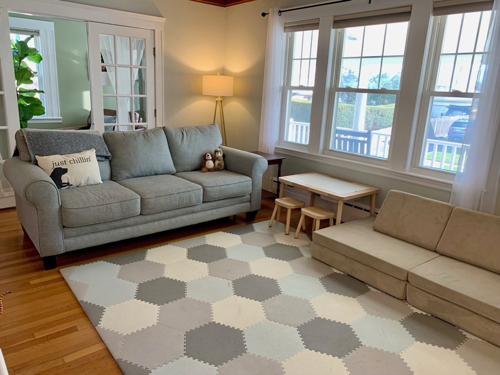 15 Maypole Road Quincy, MA 02169 - Photo 11 of 28 a living room with furniture and a large window