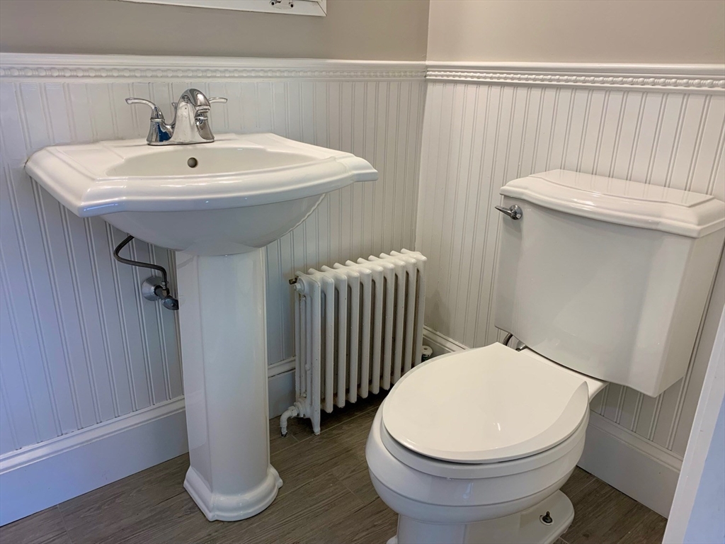 15 Maypole Road Quincy, MA 02169 - Photo 15 of 28 a bathroom with a sink a toilet and mirror