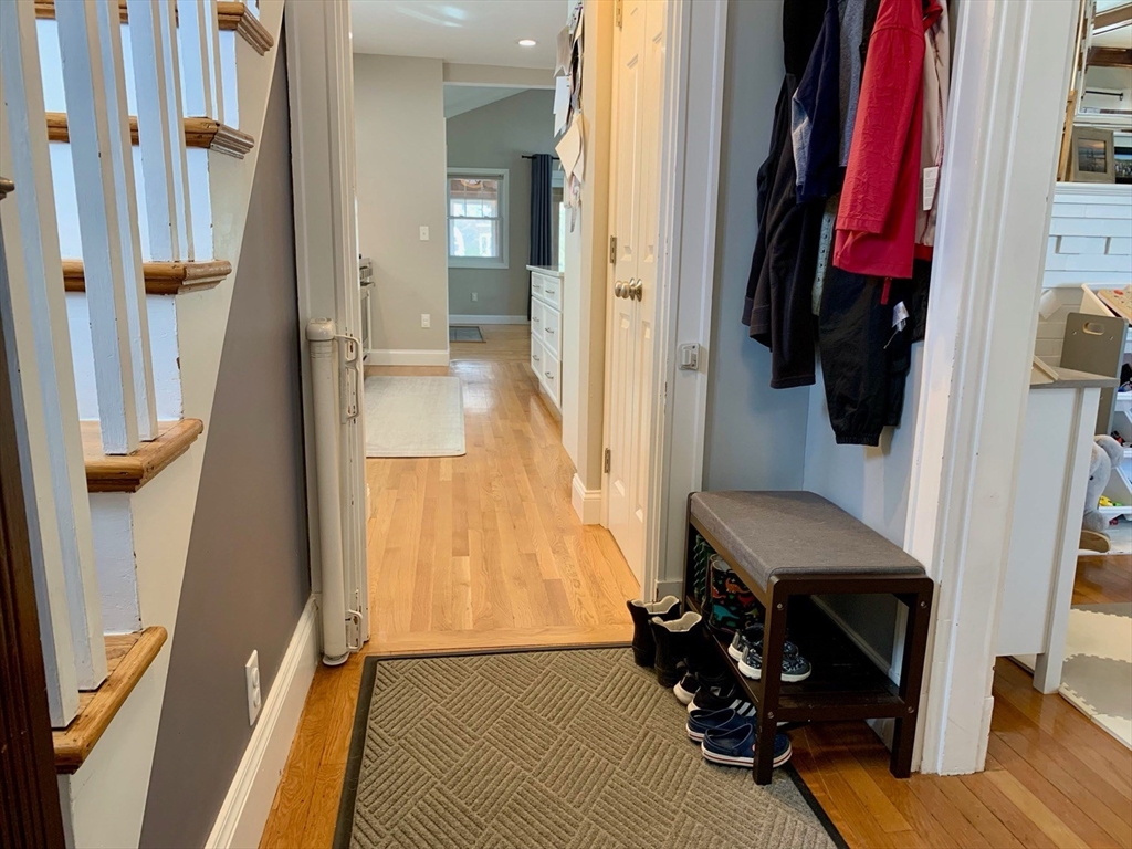 15 Maypole Road Quincy, MA 02169 - Photo 19 of 28 a view of a hallway with wooden floor and stairs