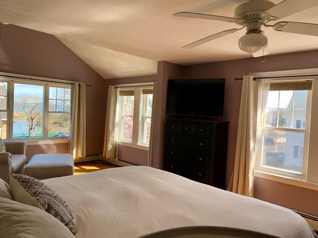 15 Maypole Road Quincy, MA 02169 - Photo 26 of 28 a bedroom with a bed and glass windows