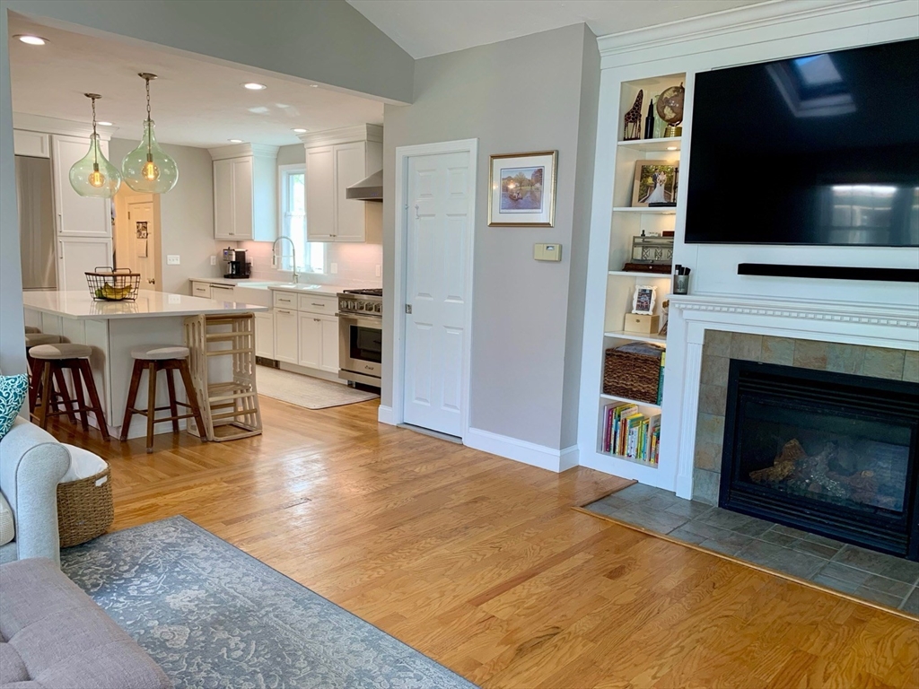 15 Maypole Road Quincy, MA 02169 - Photo 4 of 28 a open kitchen with granite countertop a stove top oven a sink a dining table and chairs
