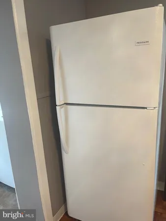 a white refrigerator freezer and a washer