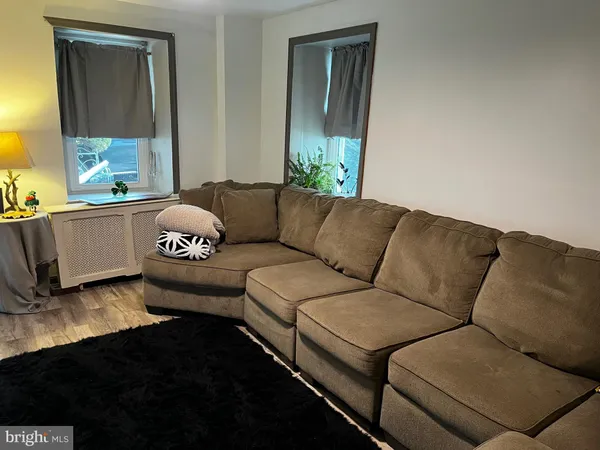 a living room with furniture and a mirror
